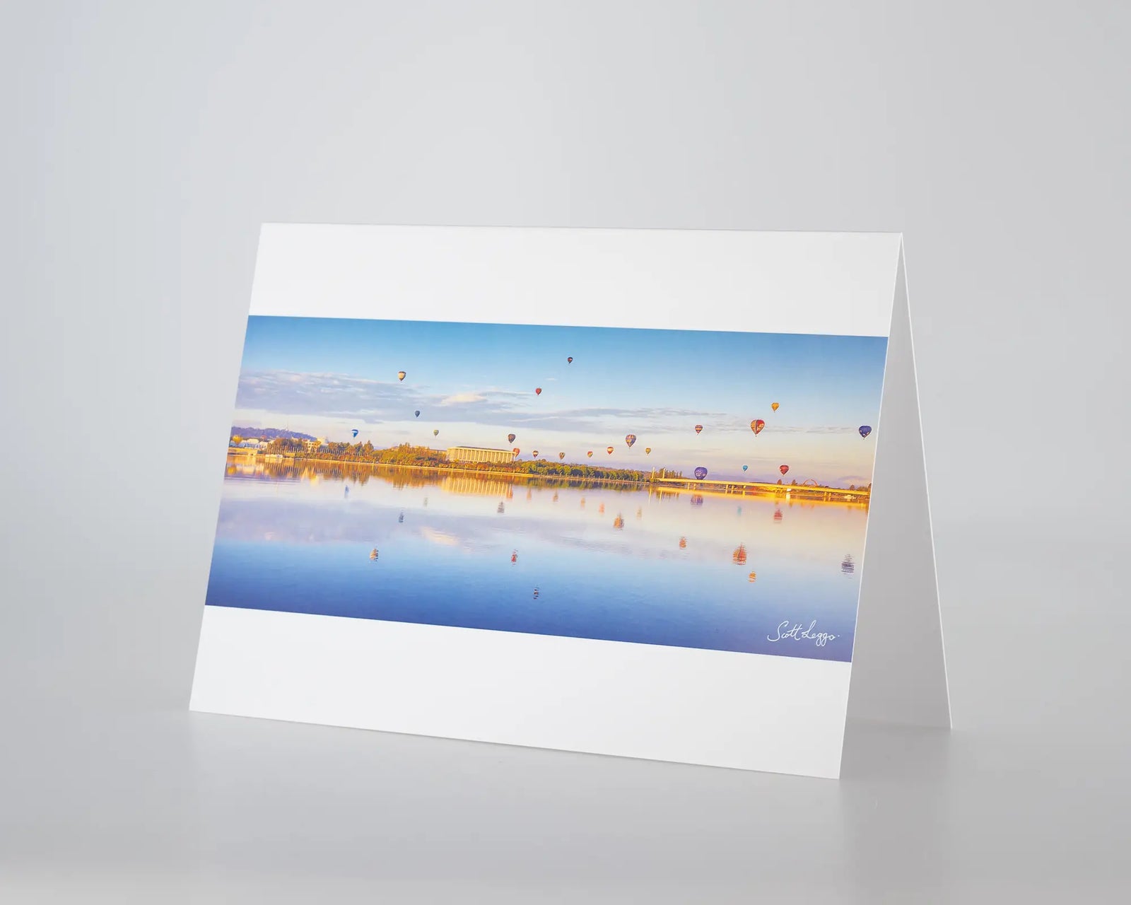 Dawn Drifters greeting card of hot air balloons over Canberra at sunrise.