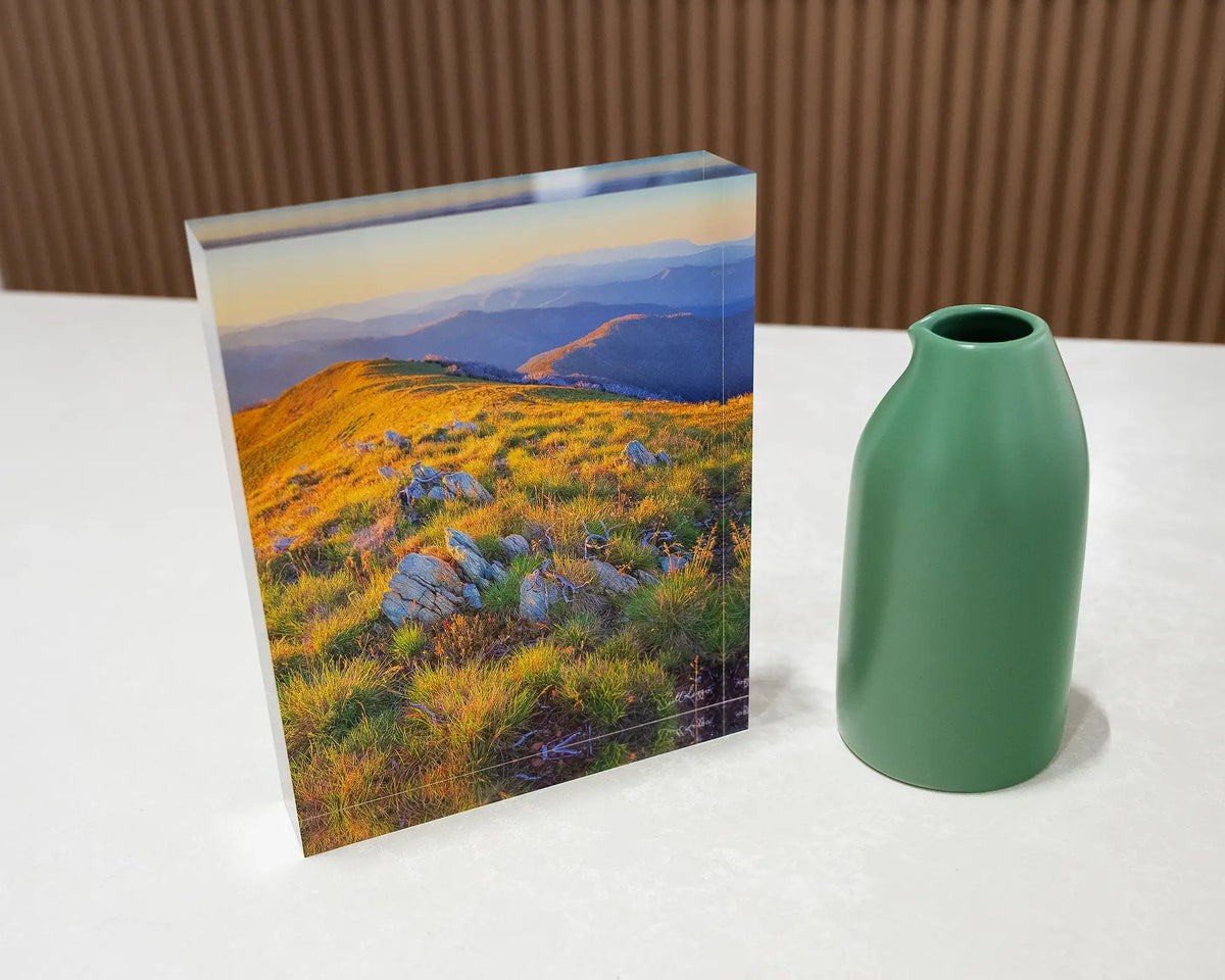 Days End. Acrylic block Alpine National Park Victoria, on desk with small vase.