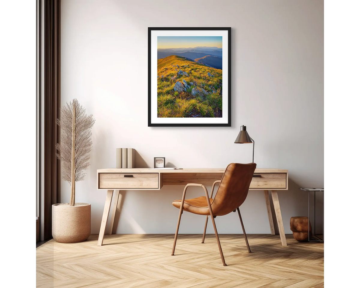 Days End. High country wall art print with a black frame hanging above a desk in an apartment. 