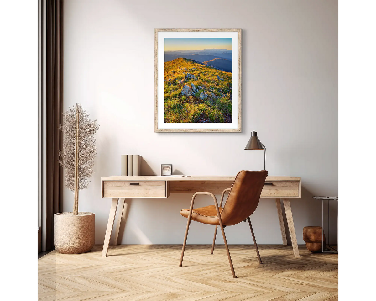 Days End. High country wall art print with a white frame hanging above a desk in an apartment. 