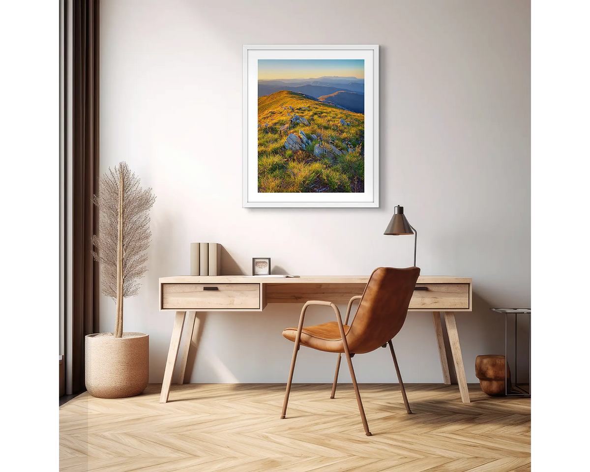 Days End. High country wall art print with a white frame hanging above a desk in an apartment. 