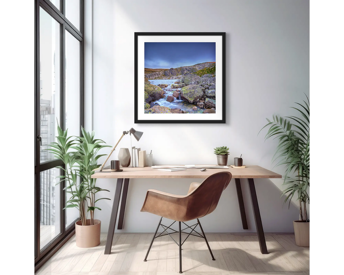 Deep Blue. Wall art print of Blue Lake in Kosciuszko National Park, with a black frame, hung above a desk in an apartment.