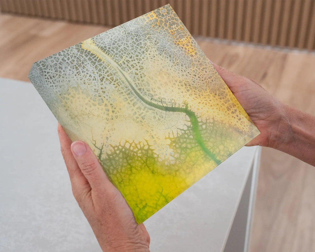 Dehydration. Acrylic block abstract aerial image of a dried dam New South Wales, held in hands.