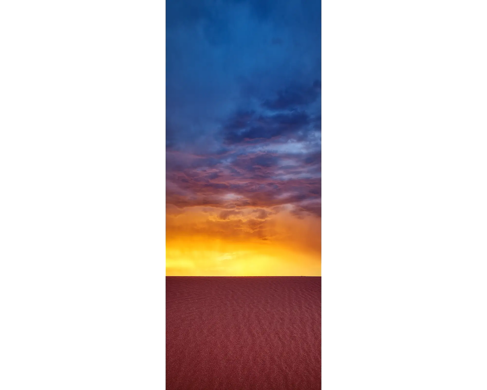 Framed photograph of a red desert at sunset and a stormy sky.