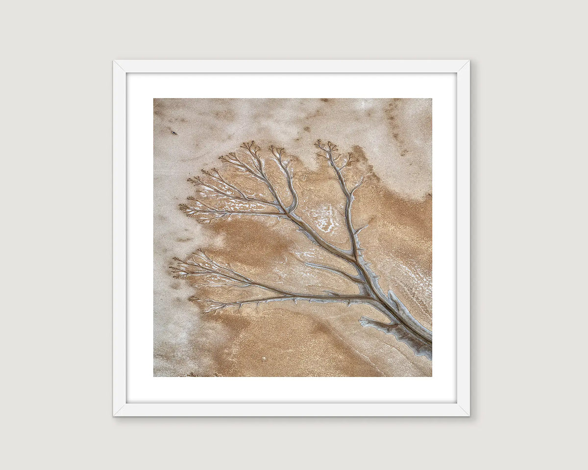 Framed photographic wall art of patterns made by the King River tidal flats from an aerial view. 