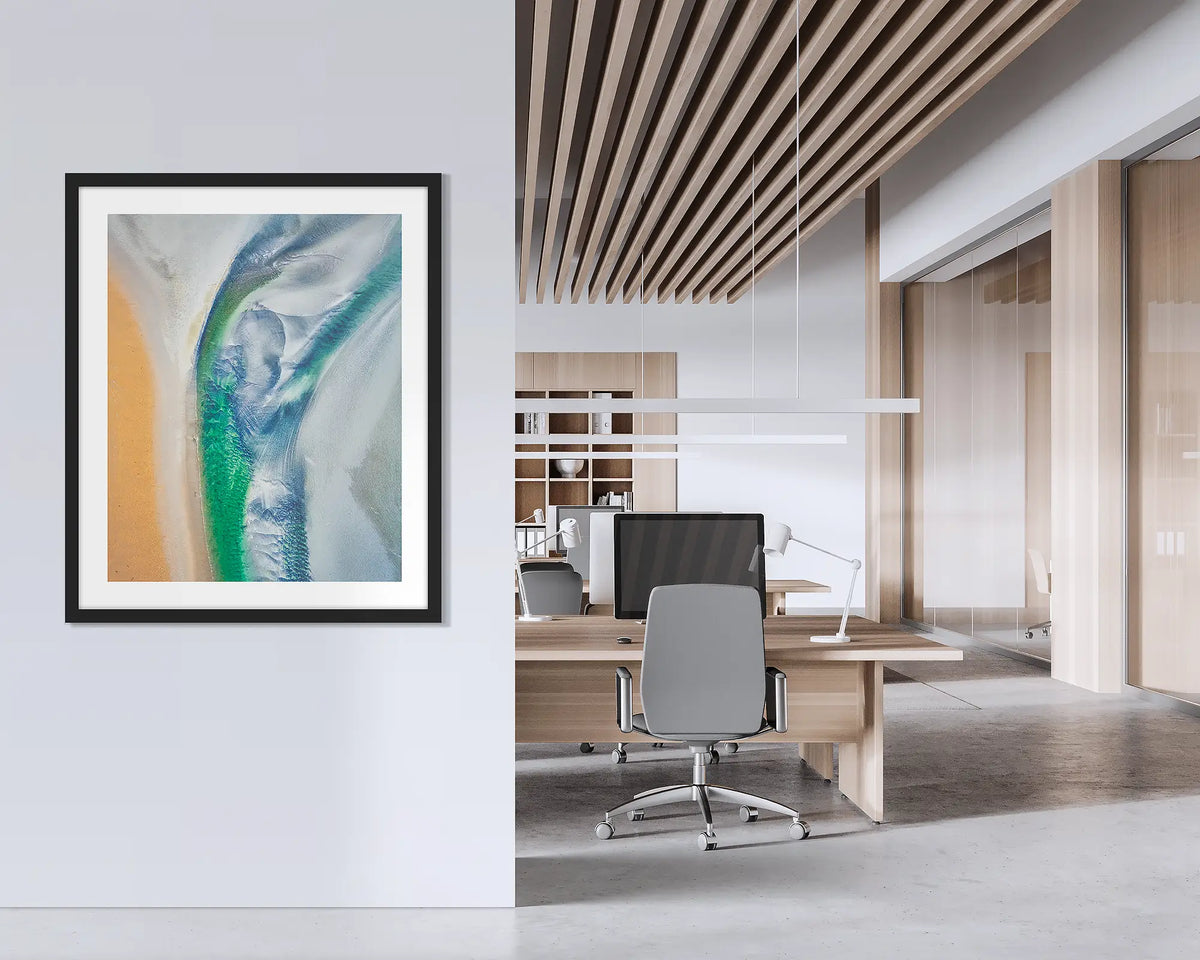 Displacement. Framed abstract Kimberley wall art print, with a black frame, hung on an office wall. 