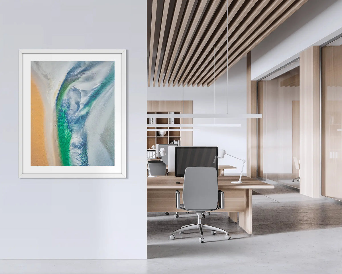 Displacement. Framed abstract Kimberley wall art print, with a white frame, hung on an office wall. 