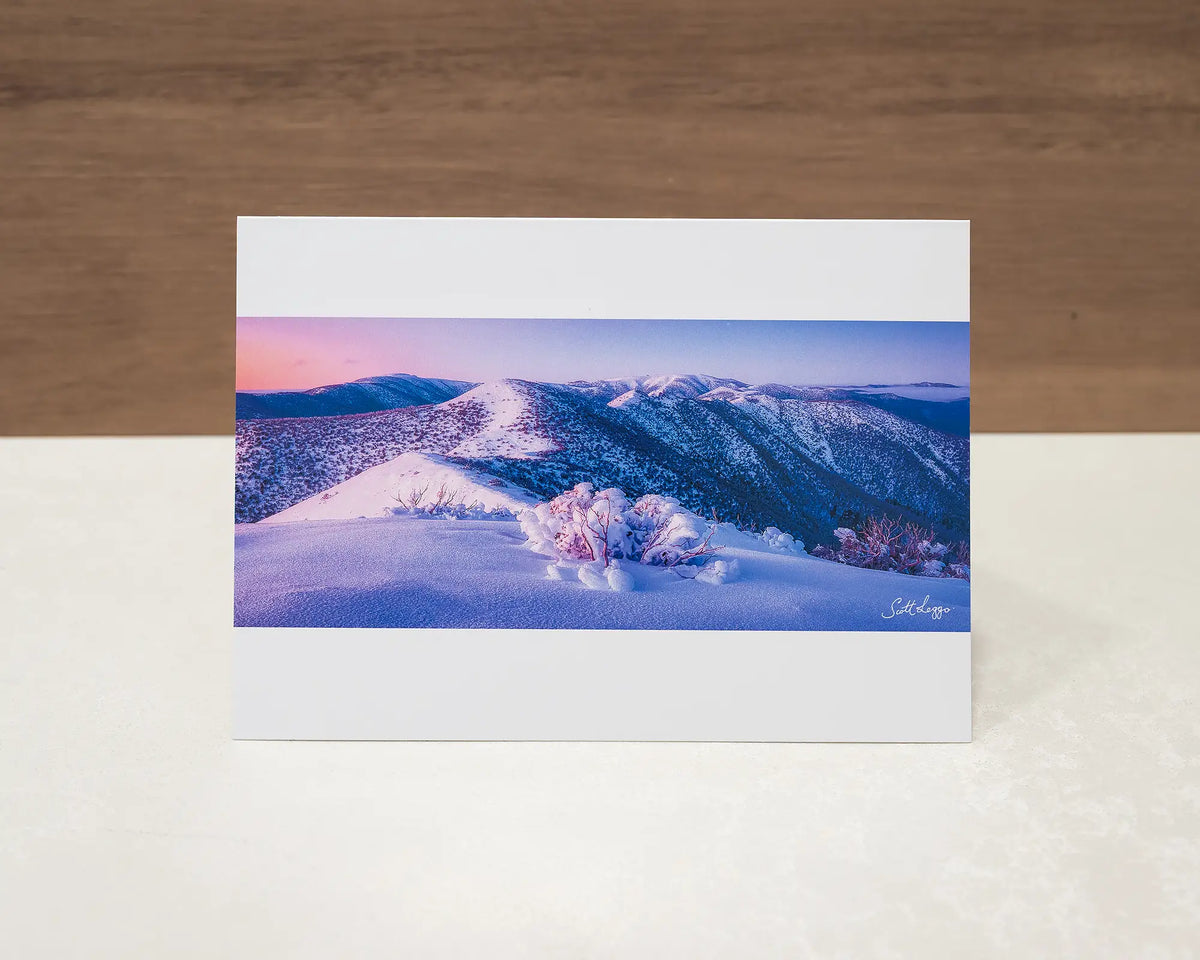 Distance greeting card of sunrise over Victorian alps, sitting on desk.