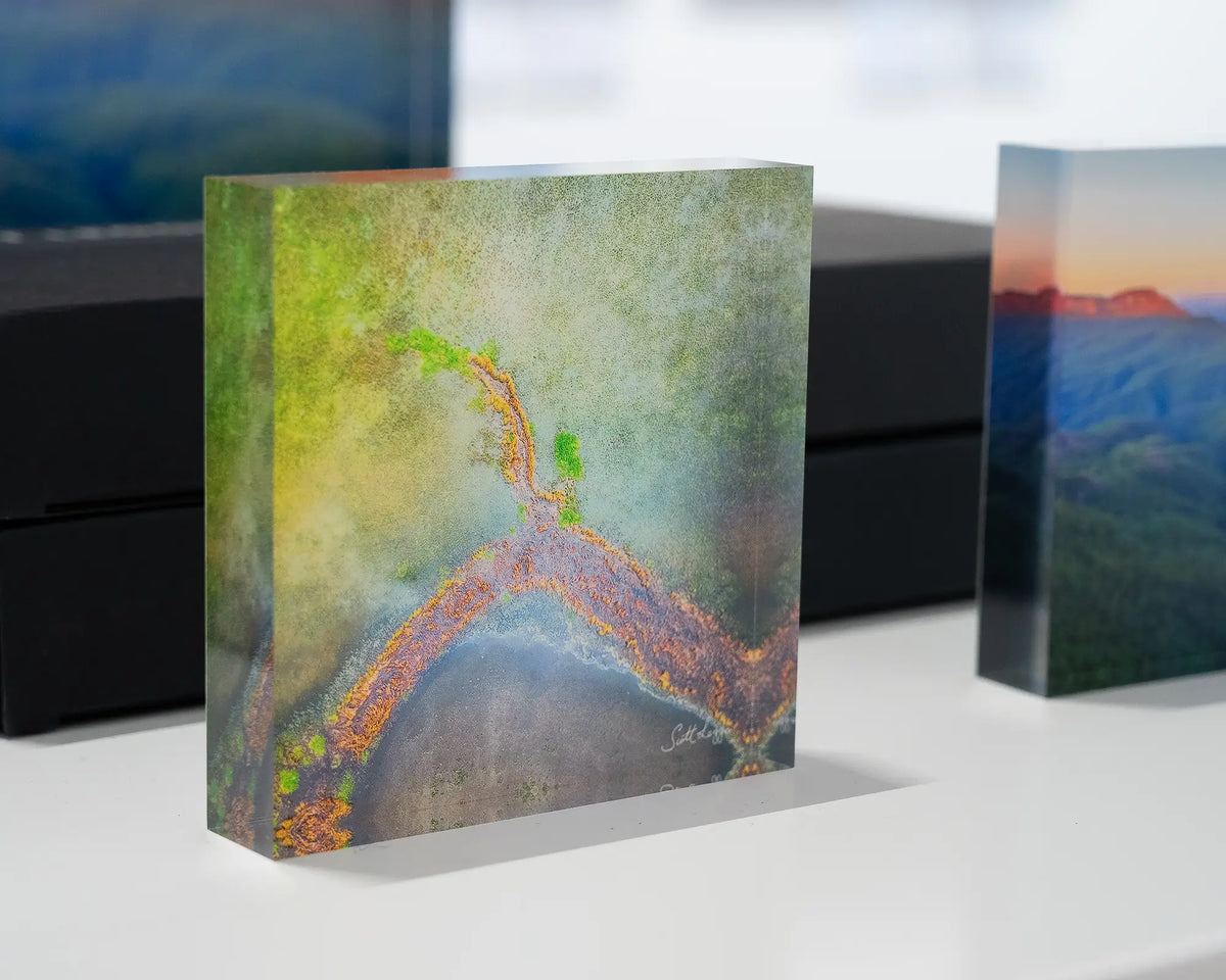 Divergent. Acrylic block abstract aerial view of Lake George, on display in gallery.