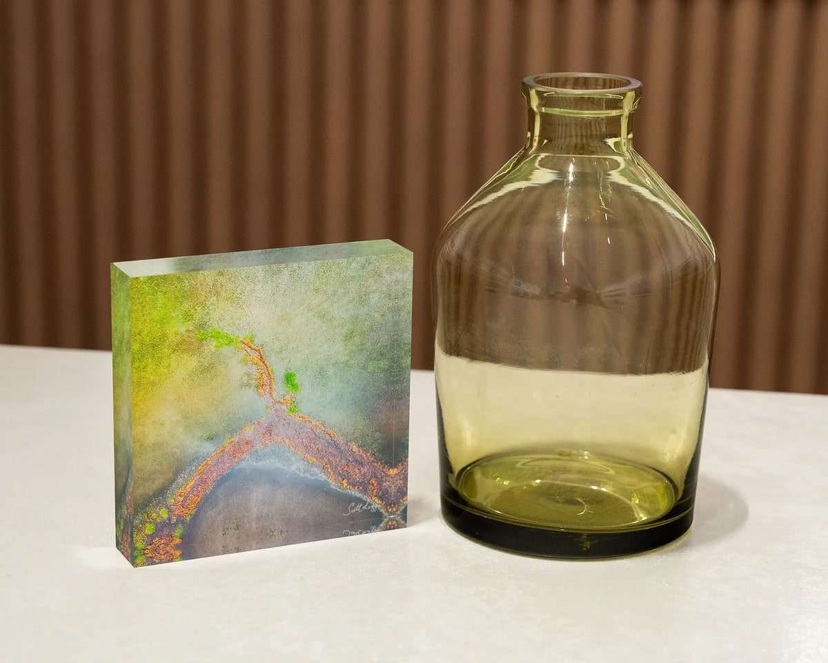 Divergent. Acrylic block abstract aerial view of Lake George, styled with a small vase.