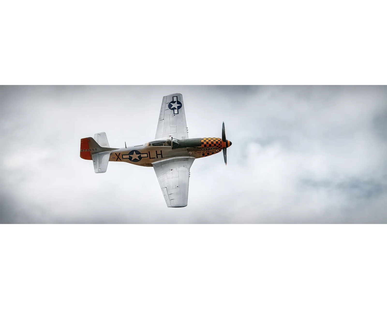 P-51 Mustang flying through clouds. 