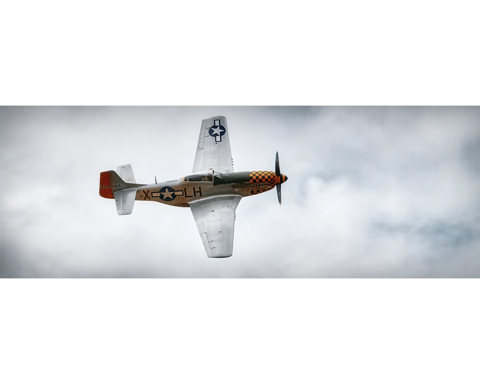 P-51 Mustang flying through clouds. 
