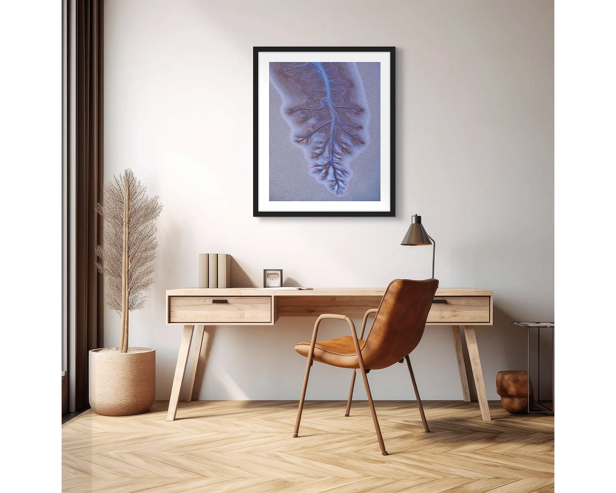 Downfall. Abstract Kimberley wall art print with a black frame hanging above a desk in an apartment. 
