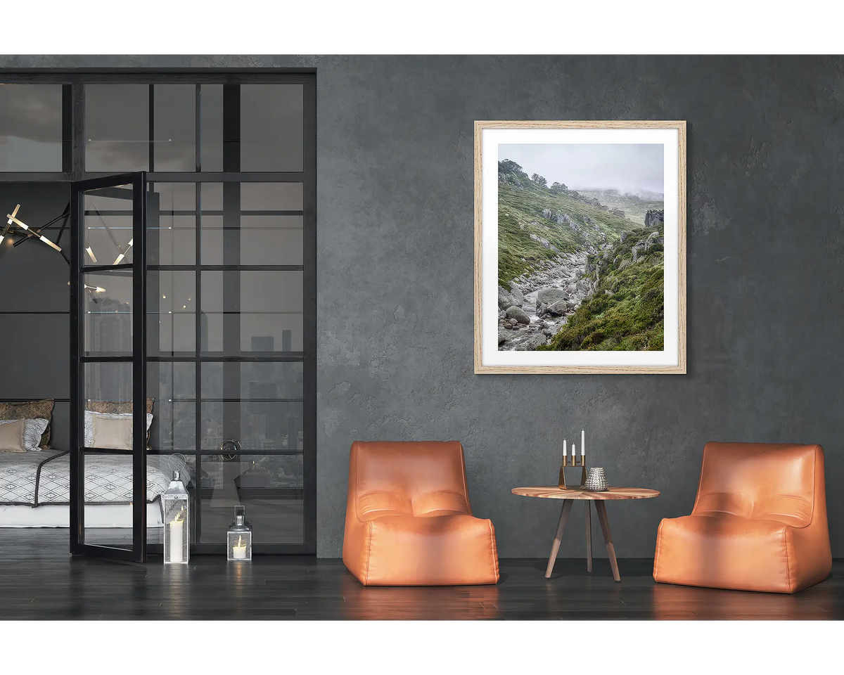 Downstream. Framed wall art print of the Snowy River, with a timber frame hung in a loft apartment. 