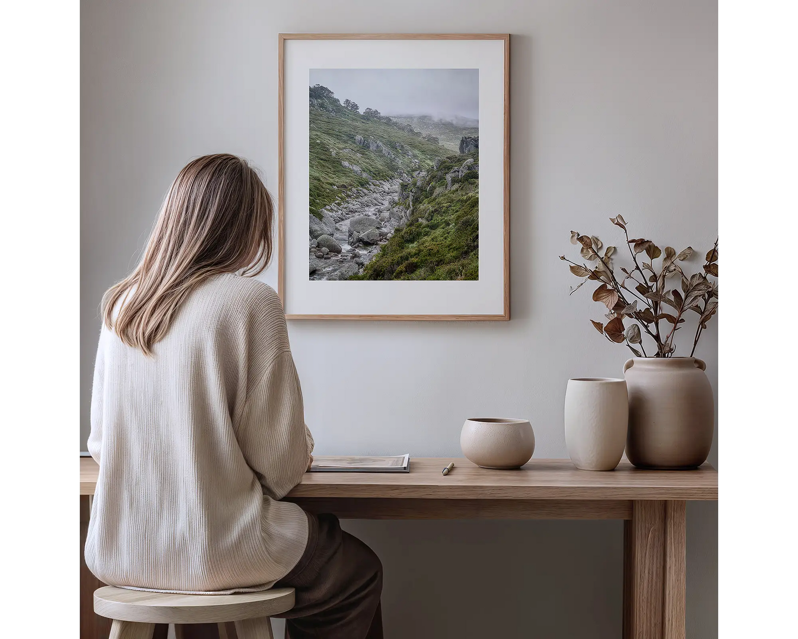 Framed photograph of grasslands and the Snowy River in mist and rain. 