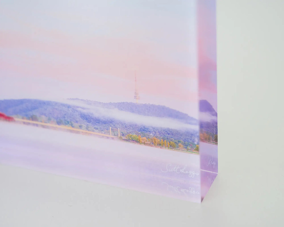Dreamy Canberra. Acrylic block soft pink sky over Lake Burley Griffin, close up corner details.