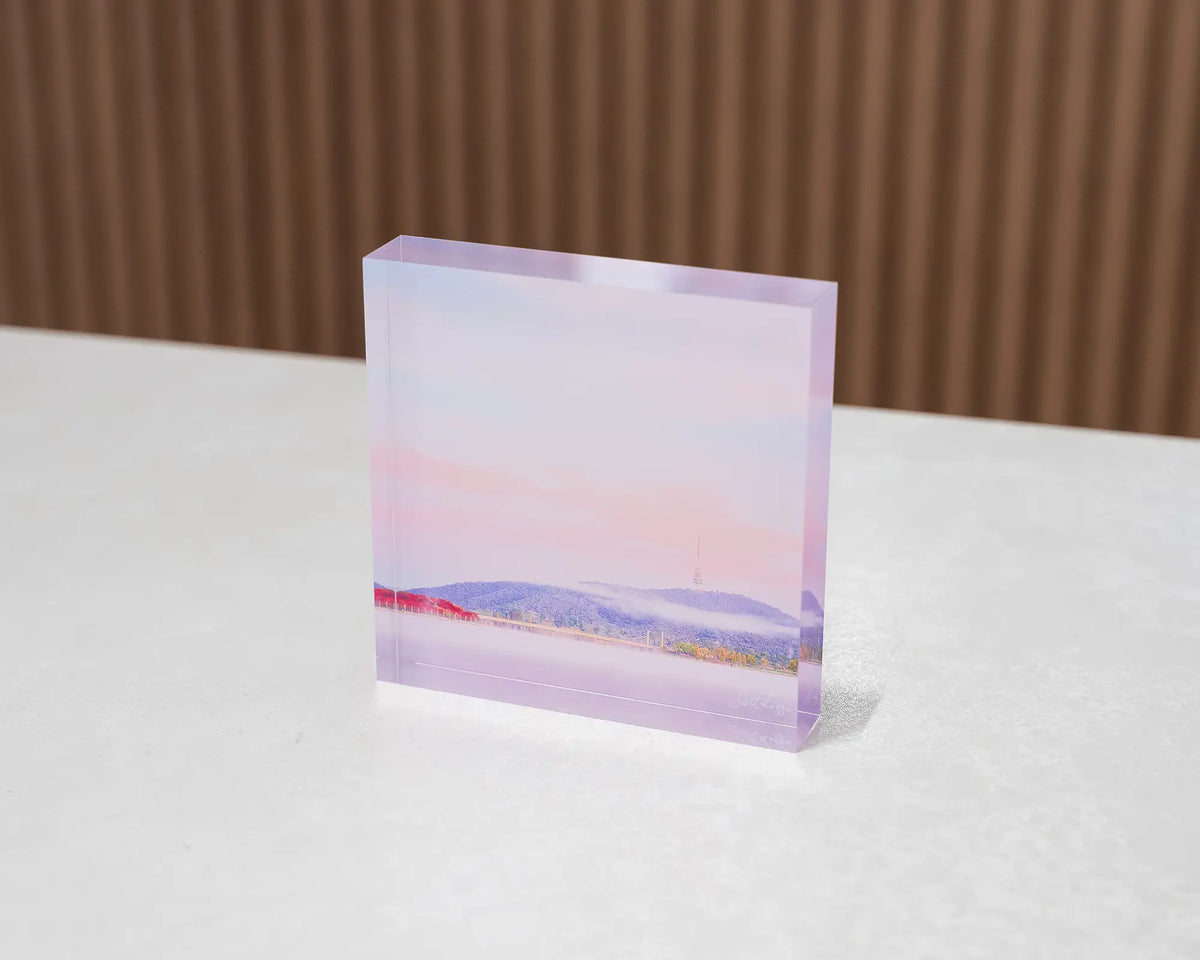 Dreamy Canberra. Acrylic block soft pink sky over Lake Burley Griffin, sitting on desk.