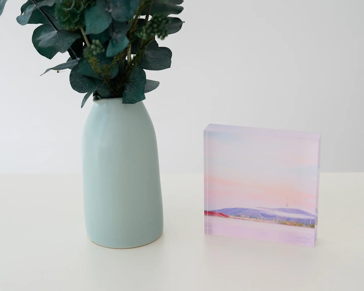 Dreamy Canberra. Acrylic block soft pink sky over Lake Burley Griffin, styled with a flower vase.
