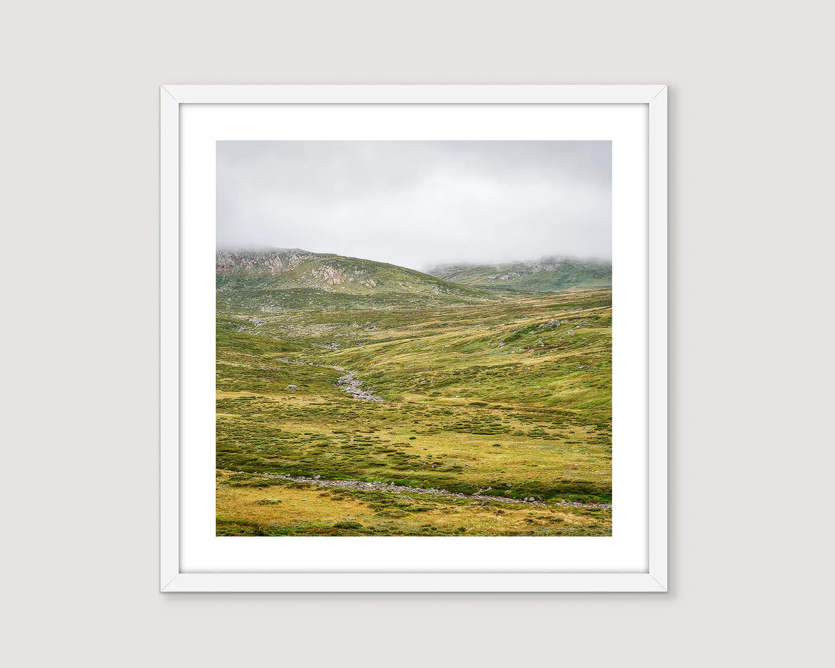 Framed photograph of the Snowy River with drizzle and fog over grasslands. 