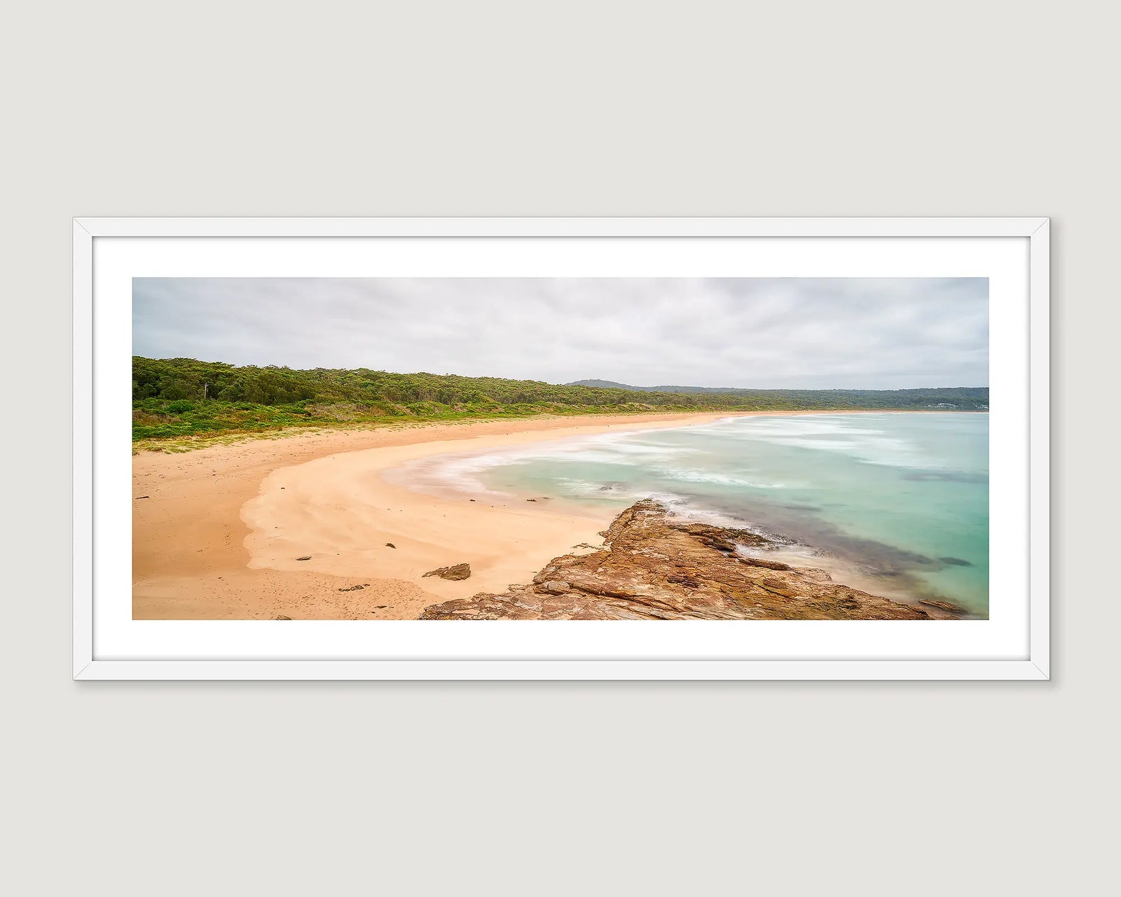 Framed photographic print of a coastal scene of South Durras beach with grey cloud and turquoise waters. 