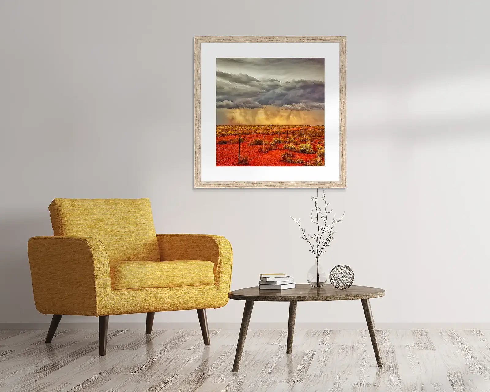 Earth tones artwork hanging above chair.