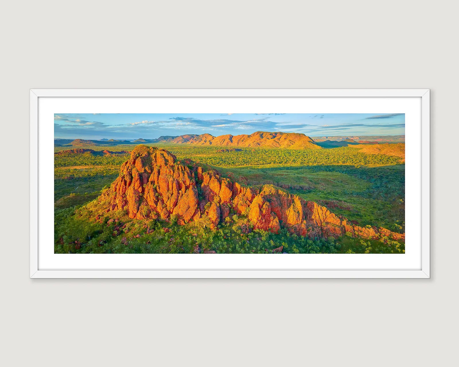 Framed photographic print of a sunset ,over a rock formation nestled amongst green bushland, in the Kimberley.
