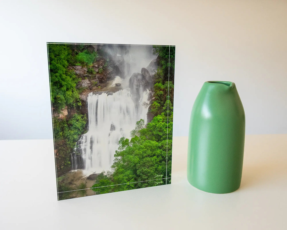 Energy. Acrylic block Fitzroy Falls, Morton National Park, on desk with a small vase.