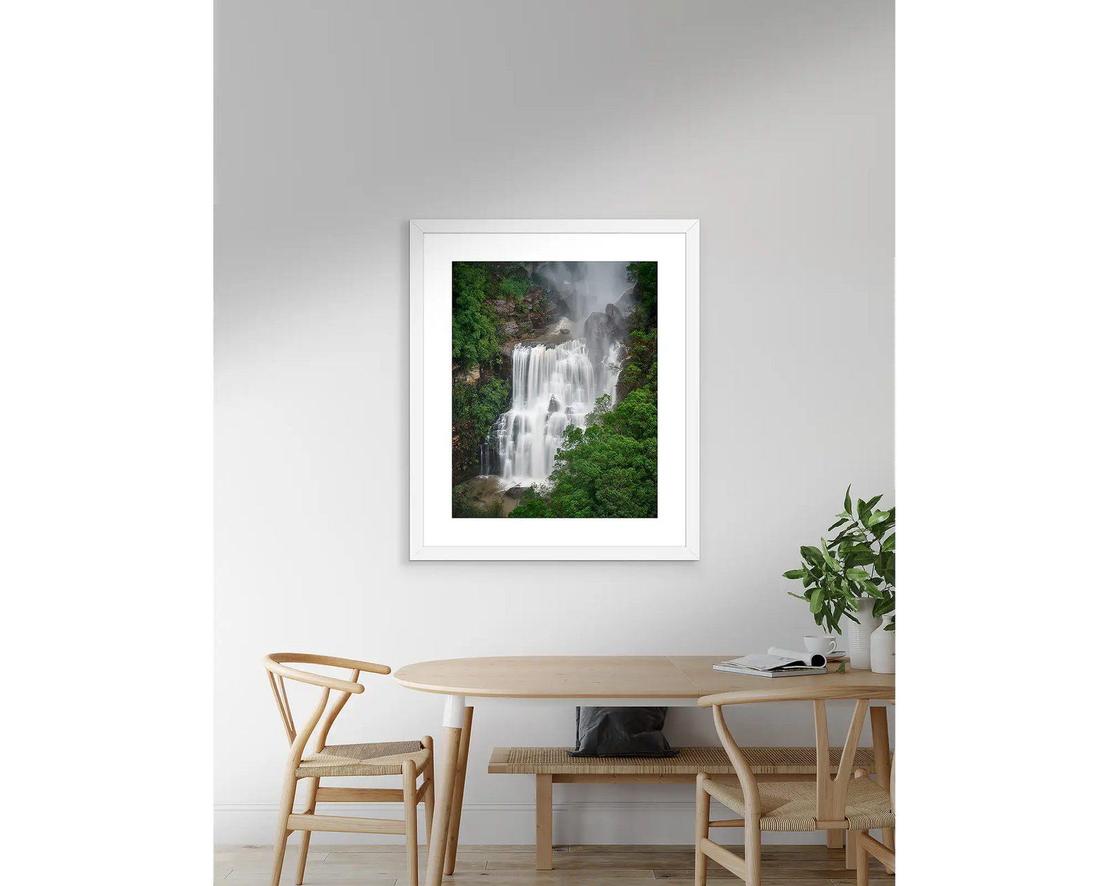 Framed wall art print of water crashing down Fitzroy Falls, throwing mist into the surrounding bush. 