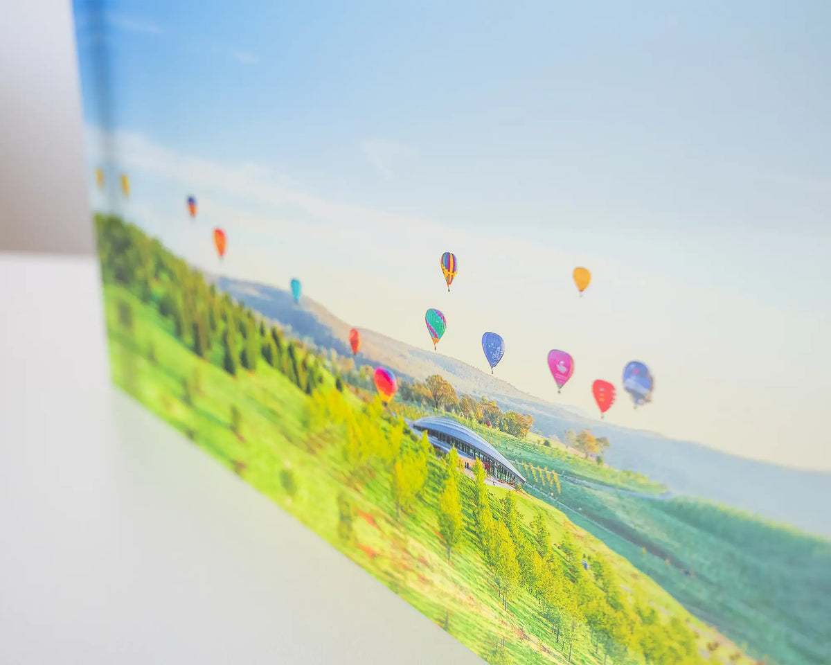 Enlighten. Acrylic block of hot air balloons over National Arboretum, Balloon Spectacular Festival, close-up details.