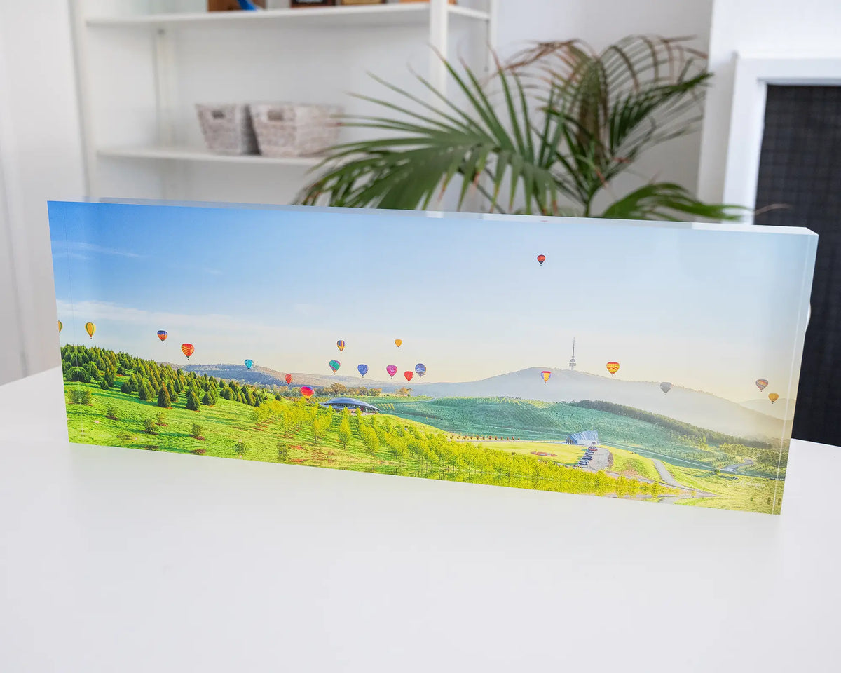 Enlighten. Acrylic block of hot air balloons sunrise over National Arboretum, Balloon Spectacular Festival, Canberra, styled in a coastal home.
