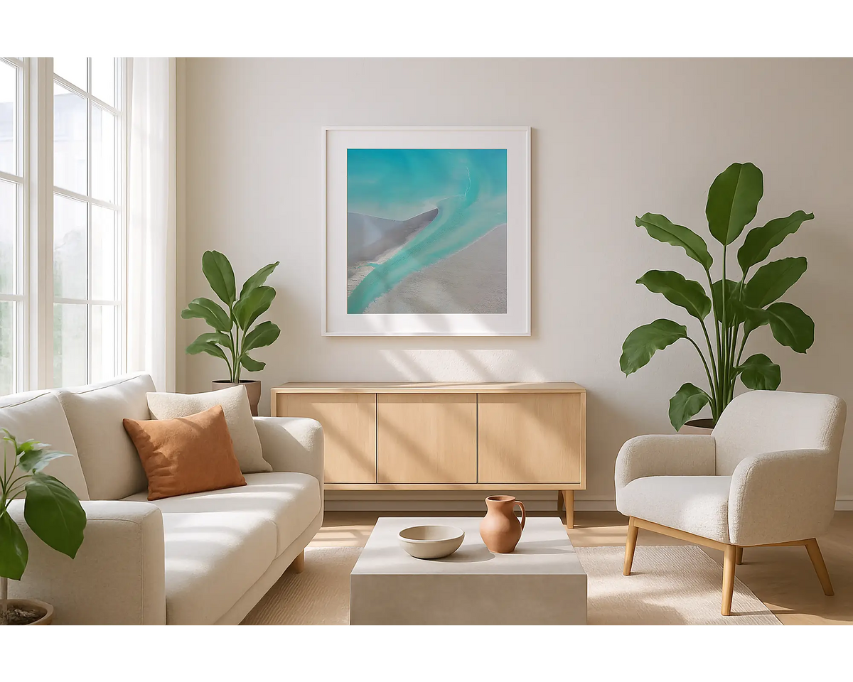 Entry. Wall art print of abstract tidal patterns, Roebuck Bay, with a white frame hung in a sunlit lounge room. 