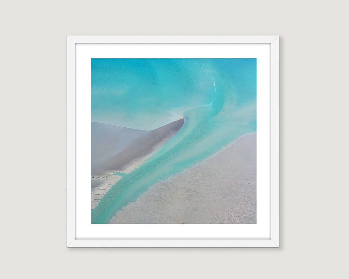 Framed aerial photographic print of aqua sea water flowing back to the ocean at Roebuck Bay. 