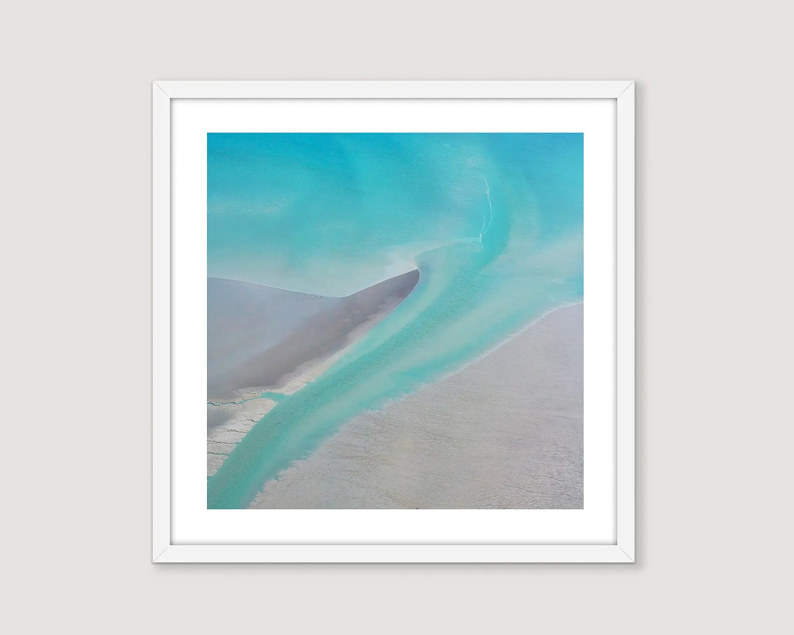 Framed aerial photographic print of aqua sea water flowing back to the ocean at Roebuck Bay. 
