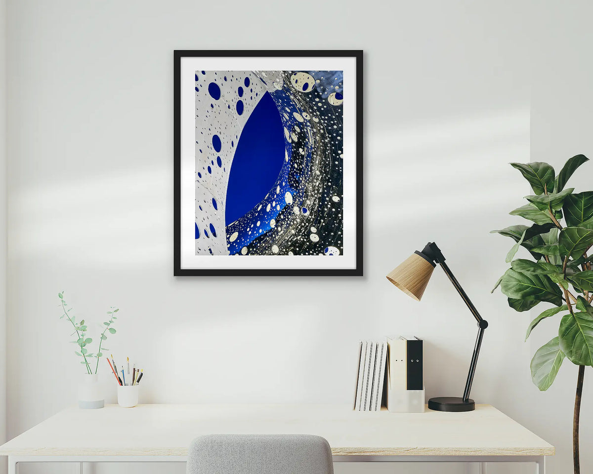 Entwine. Wall art print of the Ouroboros sculpture, framed in a black frame, and hung above an office desk. 