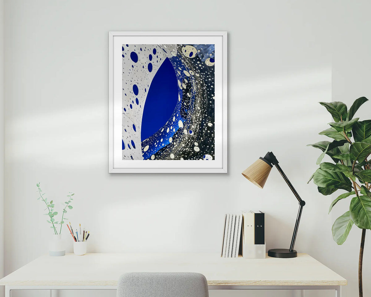 Entwine. Wall art print of the Ouroboros sculpture, framed in a white frame, and hung above an office desk. 