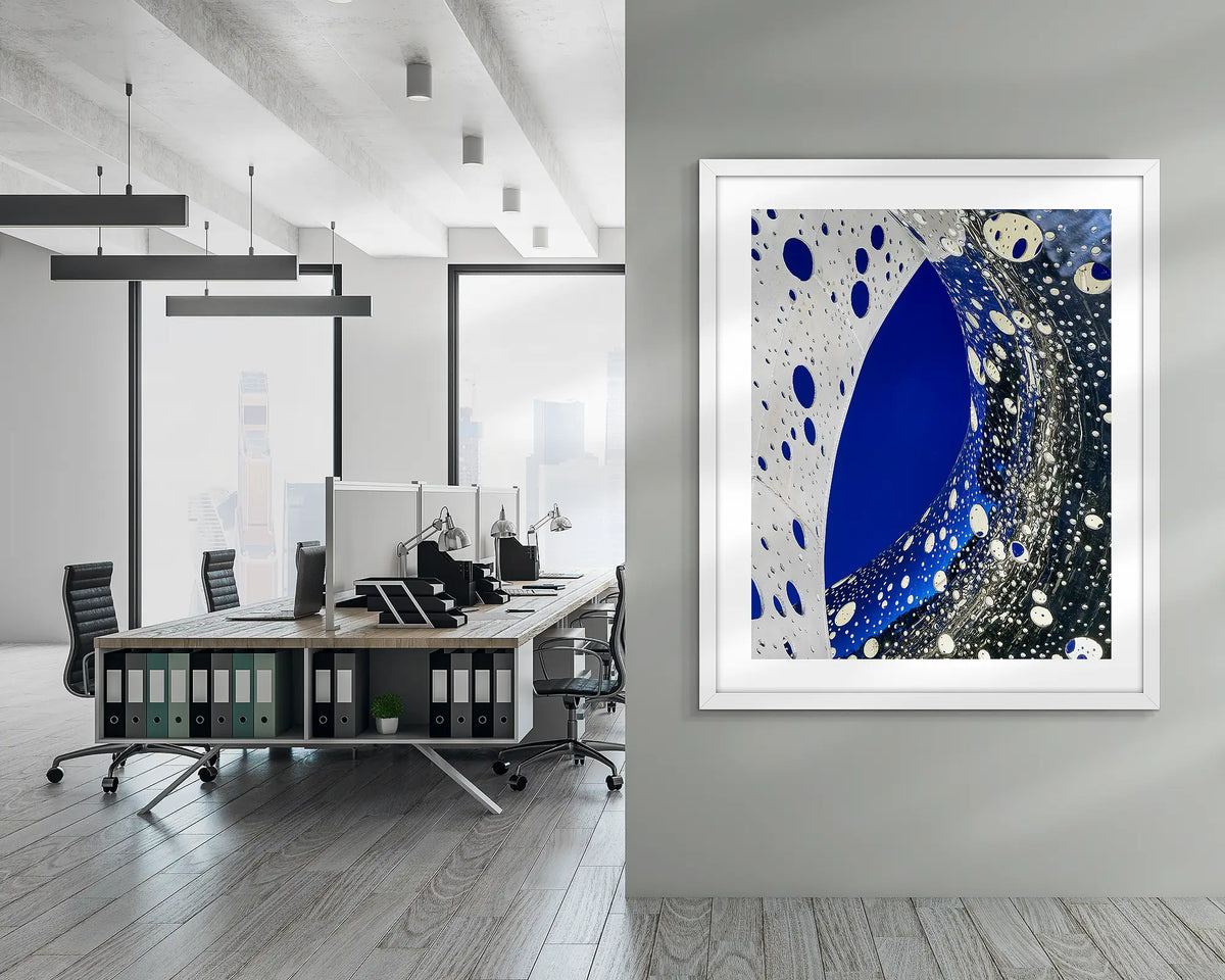 Entwine. Wall art print of the Ouroboros sculpture, framed in a white frame, and hung in a corporate office hallway. 