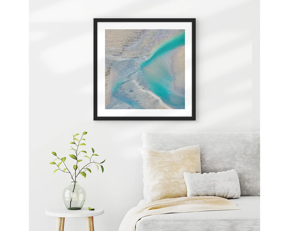 Escape. Abstract Kimberley wall art in a black frame, hanging on a bedroom wall.