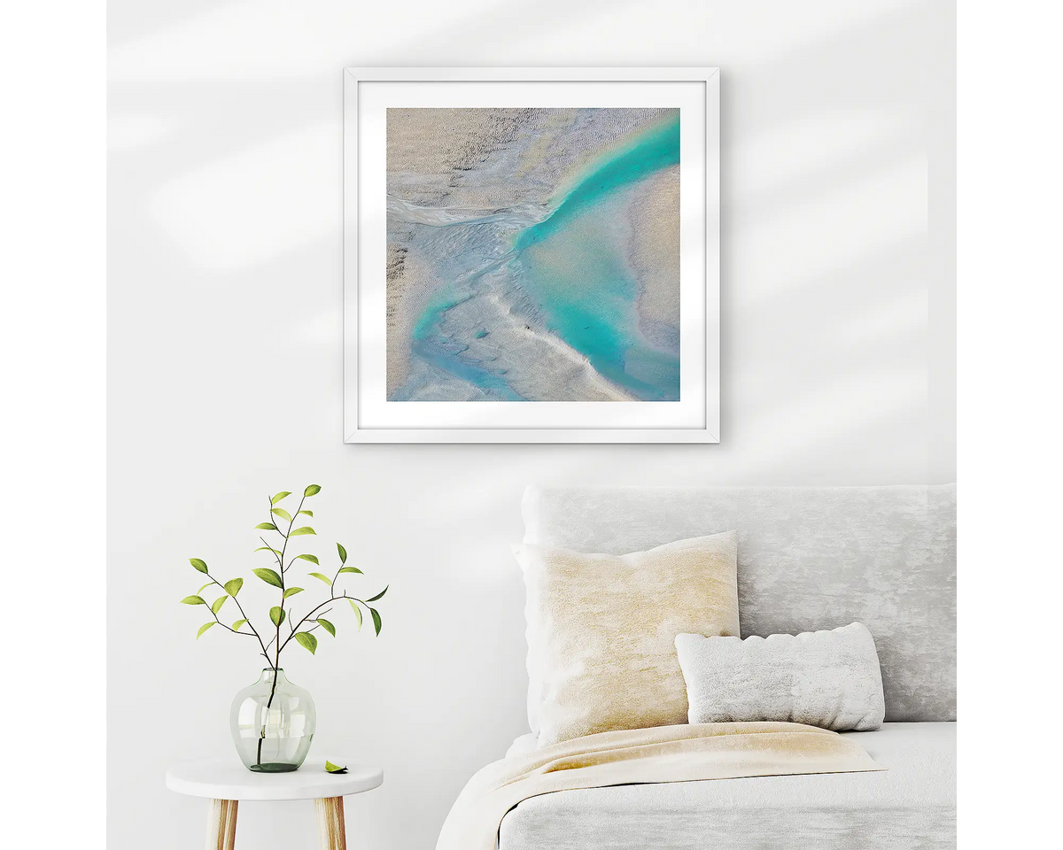 Escape. Abstract Kimberley wall art in a white frame, hanging on a bedroom wall.
