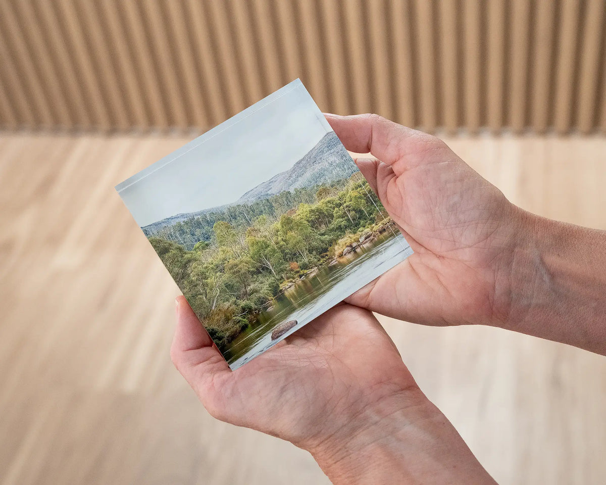 Escape to Nature. Acrylic block Thredbo River Kosciuszko National Park, being held in hands.
