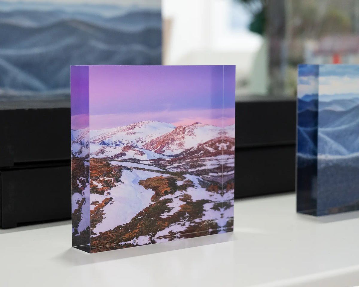 Escape To The Mountains. Acrylic block of sunset over Kosciuszko National Park, on display in gallery with more alpine acrylic blocks.