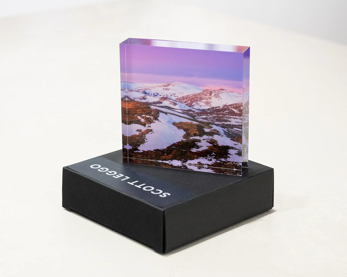 Escape To The Mountains. Acrylic block of sunset over Kosciuszko National Park, placed on a gift box.