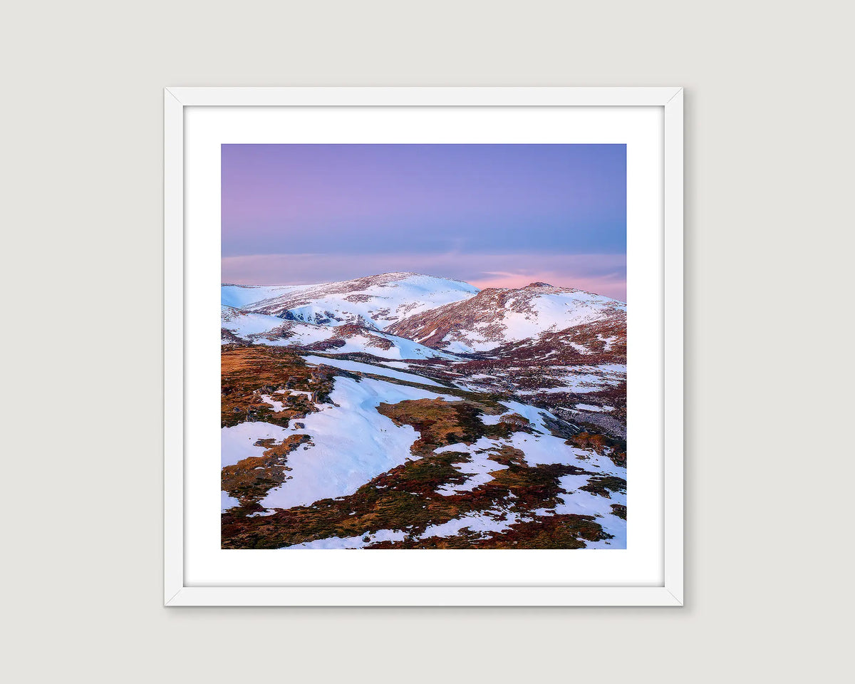 Framed wall art print of a sunset on Mount Twynam, partially covered in snow. 