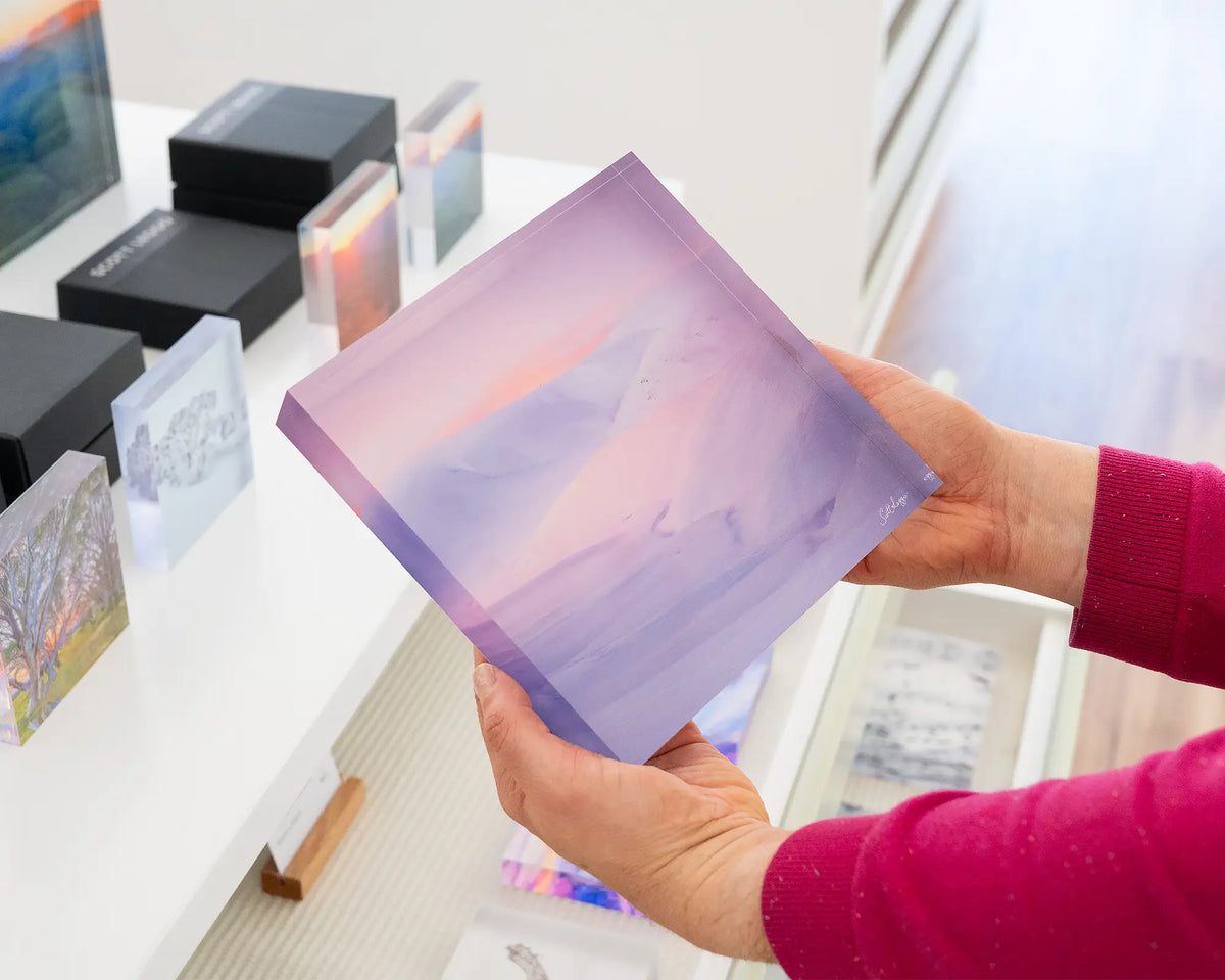 Essence of the Snowy. Acrylic block of sunset over snow covered mountains, Kosciuszko National Park, being hand held.