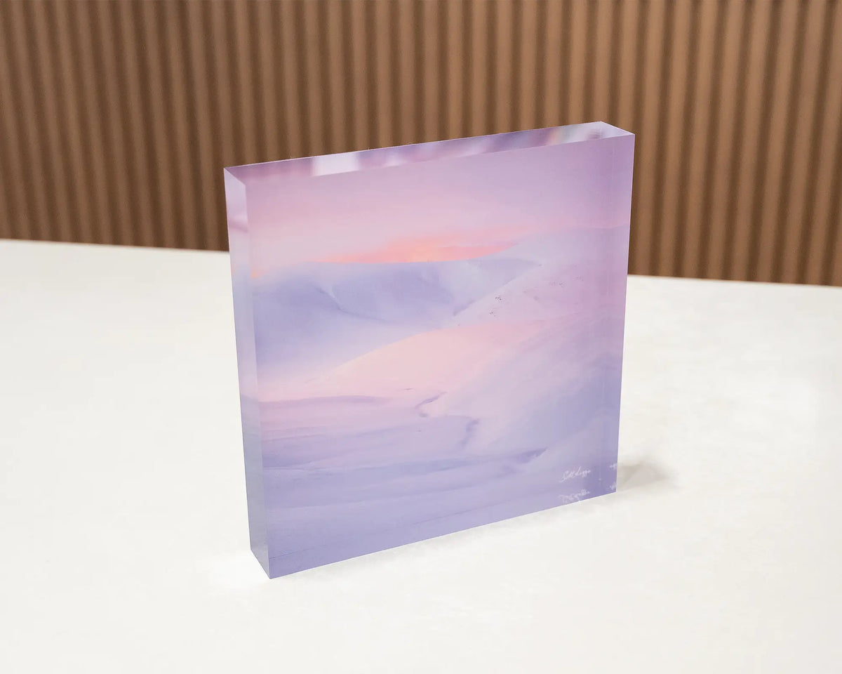 Essence of the Snowy. Acrylic block of sunset over snow covered mountains, Kosciuszko National Park, sitting on a desk.