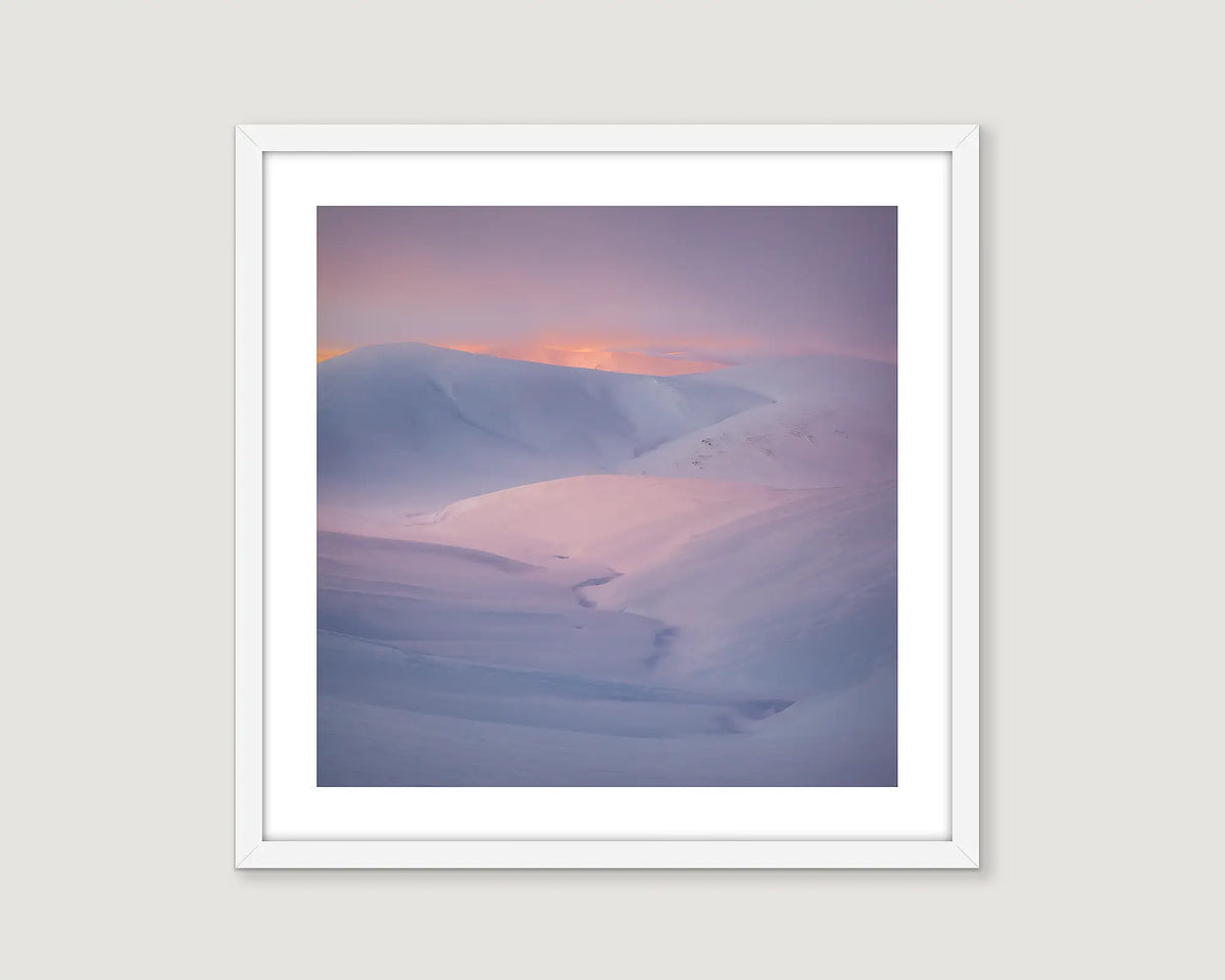 Framed wall art print of a sunset reflecting on the snow covered Snowy River. 