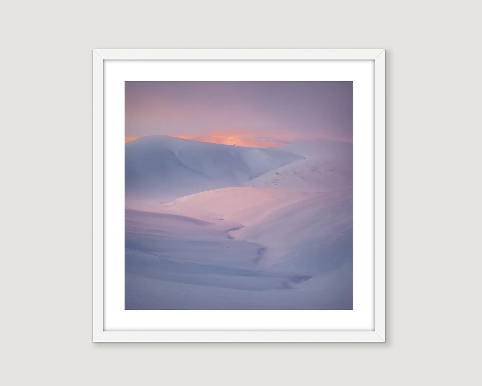 Framed wall art print of a sunset reflecting on the snow covered Snowy River. 