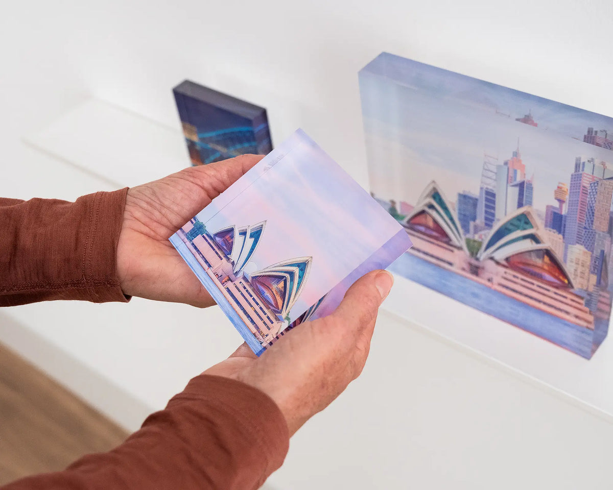 Evening at the Opera. Acrylic block of Sydney Opera House at sunset, being hand held.