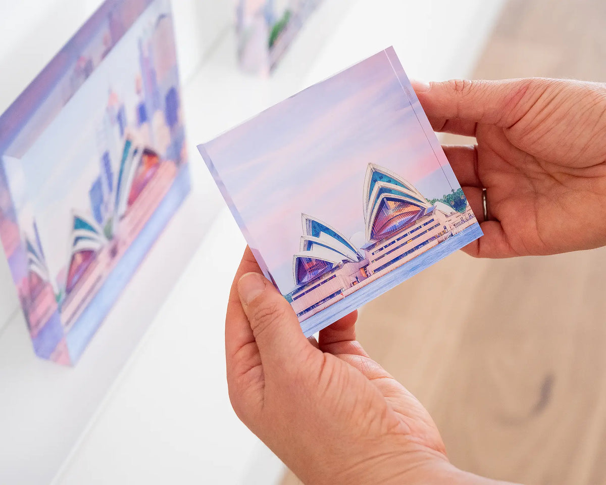 Evening At The Opera. Acrylic block of Sydney Opera House at sunset, held in hands.