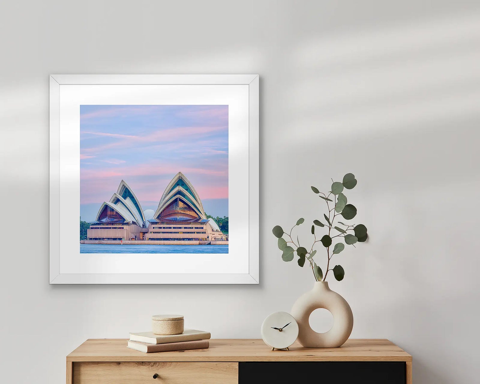 Evening at the opera. Sydney Opera House at sunset with a pink sky.