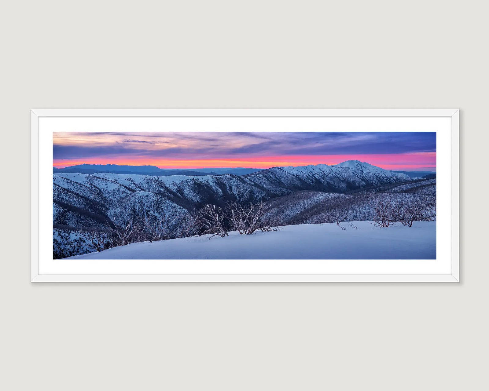 Framed wall art print of a sunset over Mount Feathertop, covered in snow. 